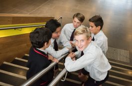Year 7 boys on the Middle school stairs in casual conversation