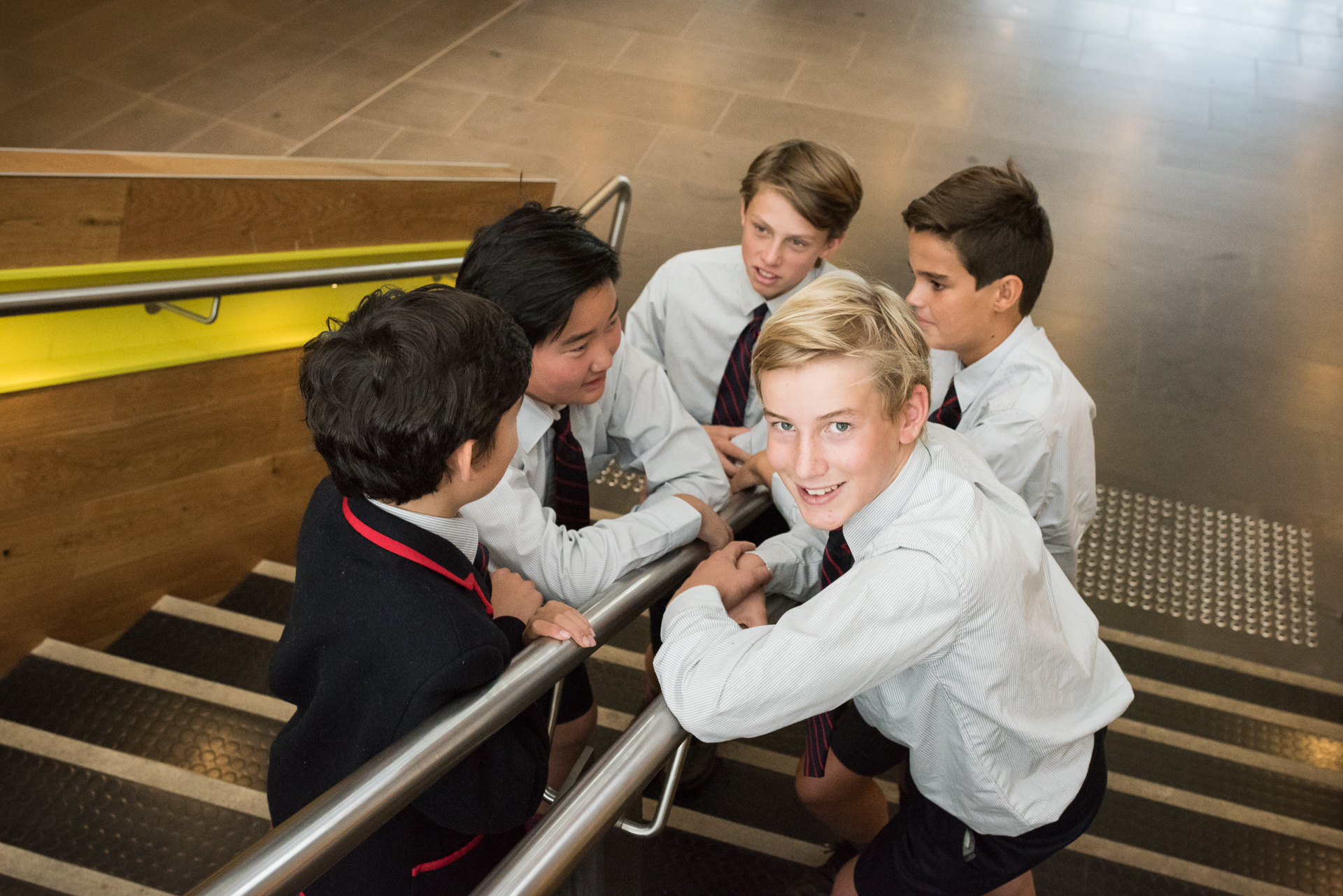 Year 7 boys on the Middle school stairs in casual conversation